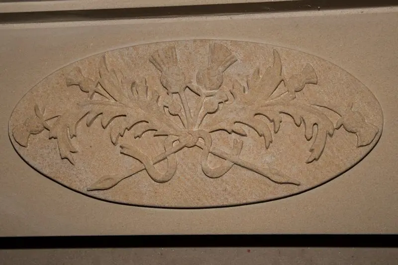 carved central thistle crest